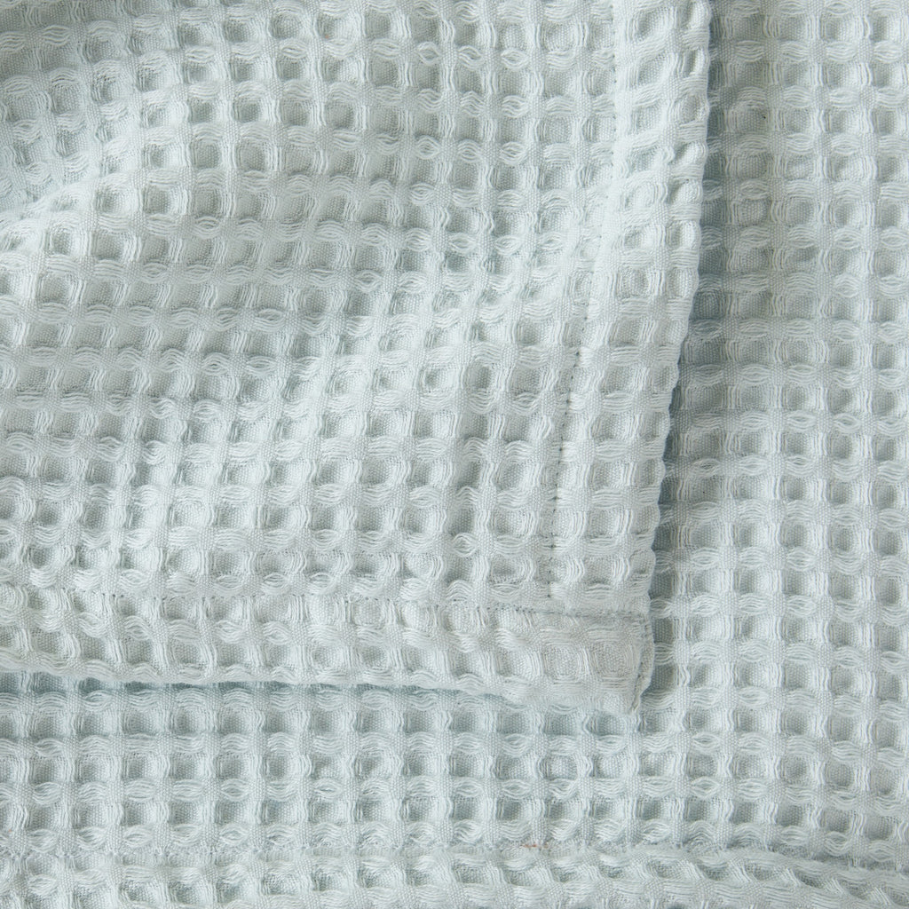 Brielle Collection Cotton Waffle Blanket by Market & Place featuring soft, breathable 100% cotton construction with a classic waffle weave texture. Available in multiple colors and shown folded, layered on beds, and in detailed fabric close-ups, highlighting its lightweight comfort and versatile year-round style.