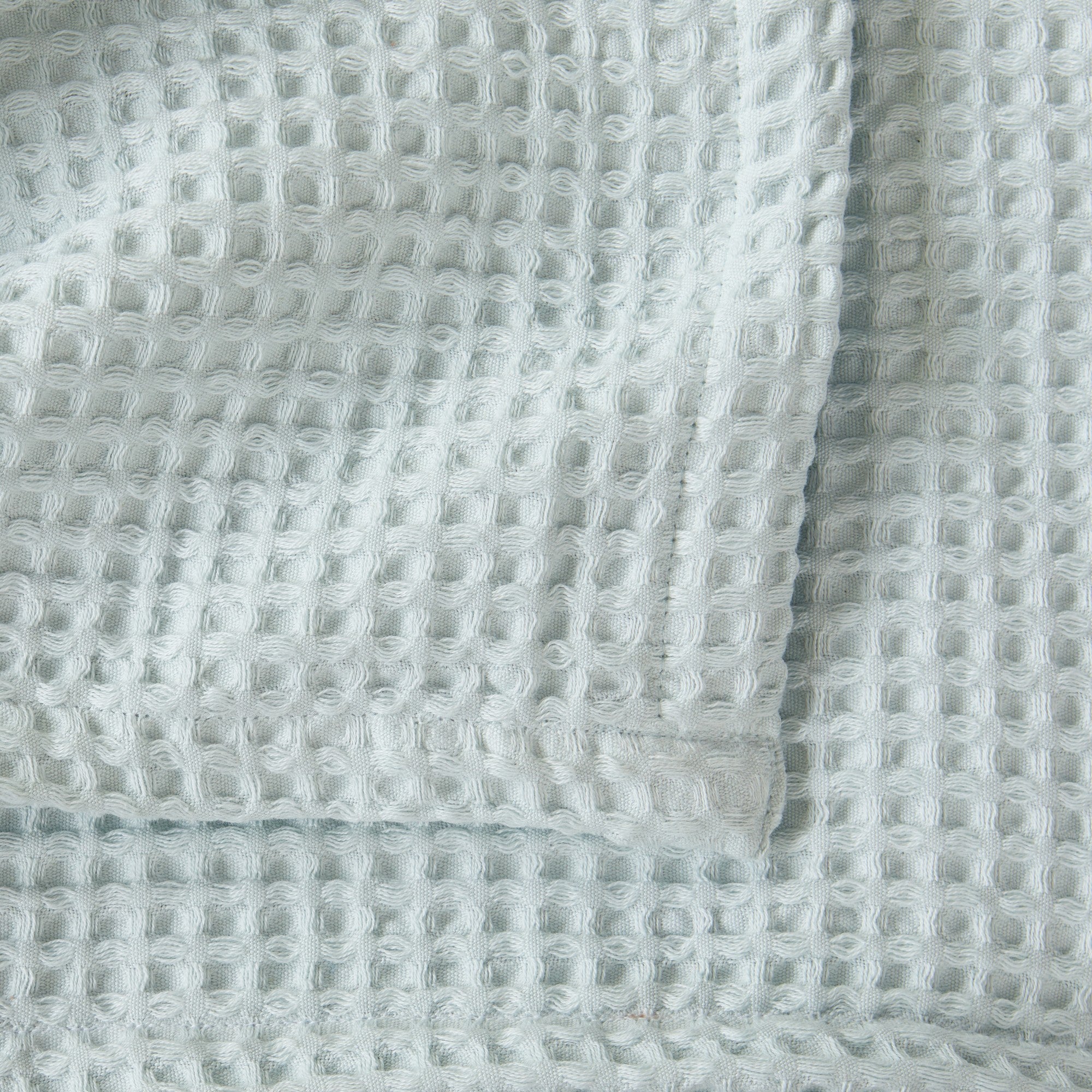 Brielle Collection Cotton Waffle Blanket by Market & Place featuring soft, breathable 100% cotton construction with a classic waffle weave texture. Available in multiple colors and shown folded, layered on beds, and in detailed fabric close-ups, highlighting its lightweight comfort and versatile year-round style.