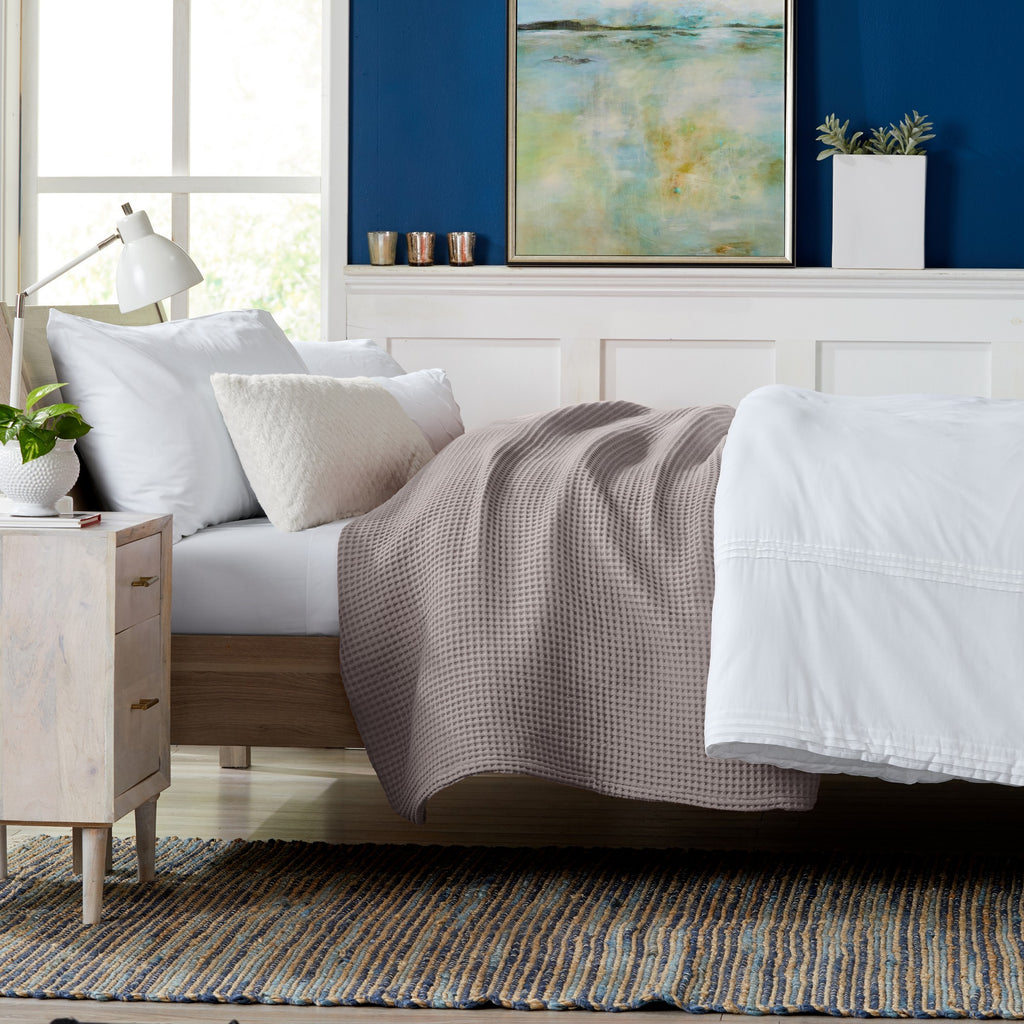 Brielle Collection Cotton Waffle Blanket by Market & Place featuring soft, breathable 100% cotton construction with a classic waffle weave texture. Available in multiple colors and shown folded, layered on beds, and in detailed fabric close-ups, highlighting its lightweight comfort and versatile year-round style.