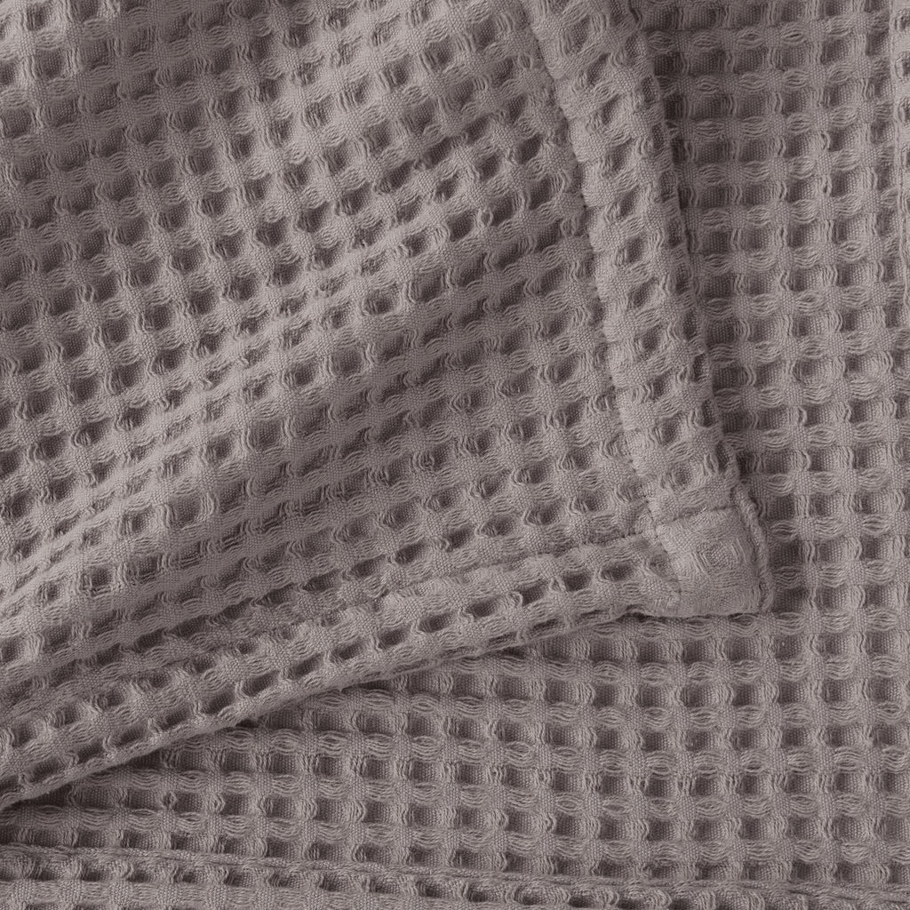 Brielle Collection Cotton Waffle Blanket by Market & Place featuring soft, breathable 100% cotton construction with a classic waffle weave texture. Available in multiple colors and shown folded, layered on beds, and in detailed fabric close-ups, highlighting its lightweight comfort and versatile year-round style.