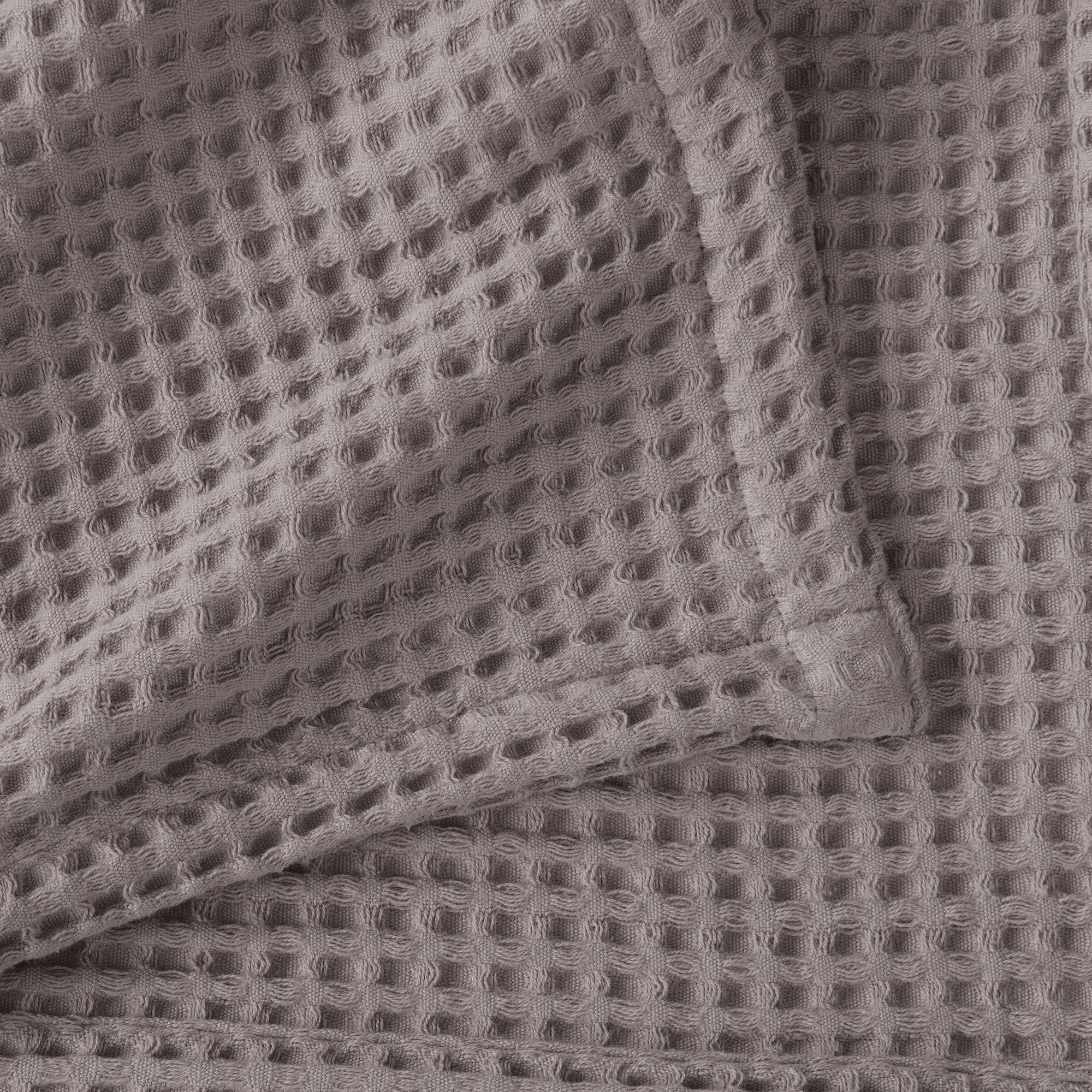 Brielle Collection Cotton Waffle Blanket by Market & Place featuring soft, breathable 100% cotton construction with a classic waffle weave texture. Available in multiple colors and shown folded, layered on beds, and in detailed fabric close-ups, highlighting its lightweight comfort and versatile year-round style.