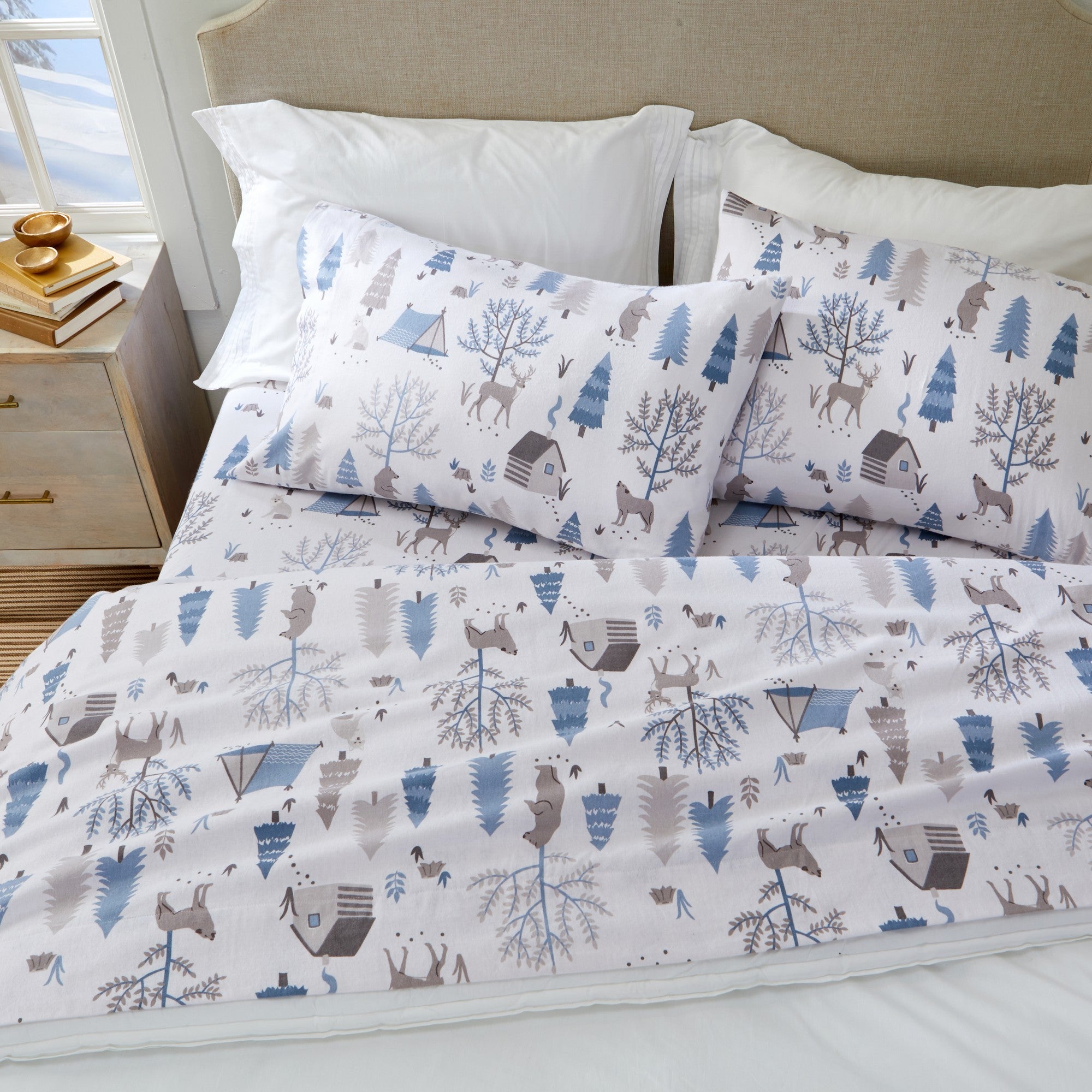 Printed 100% Turkish cotton flannel sheet set featuring assorted winter-inspired patterns, including woodland animals, snowflakes, trees, plaids, and seasonal motifs. Soft, cozy bedding shown in styled bedroom settings with close-up fabric details and folded sheet stacks in multiple designs.