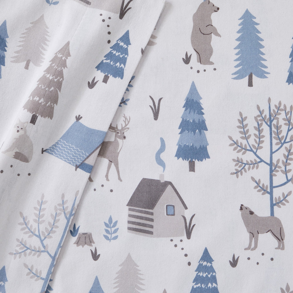 Printed 100% Turkish cotton flannel sheet set featuring assorted winter-inspired patterns, including woodland animals, snowflakes, trees, plaids, and seasonal motifs. Soft, cozy bedding shown in styled bedroom settings with close-up fabric details and folded sheet stacks in multiple designs.
