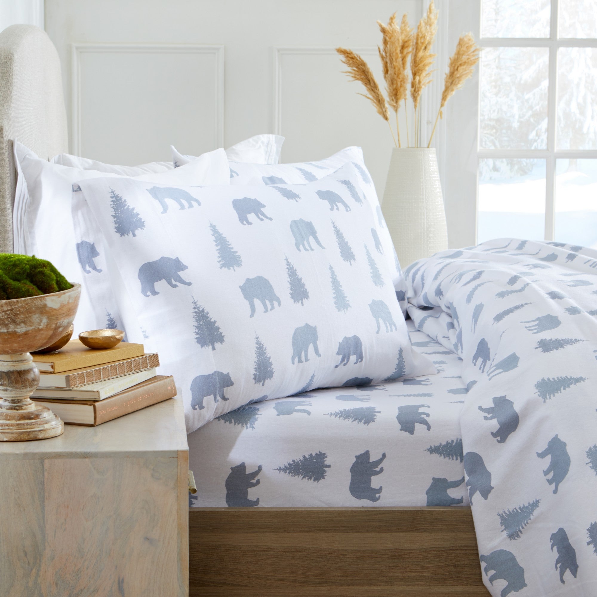 Printed 100% Turkish cotton flannel sheet set featuring assorted winter-inspired patterns, including woodland animals, snowflakes, trees, plaids, and seasonal motifs. Soft, cozy bedding shown in styled bedroom settings with close-up fabric details and folded sheet stacks in multiple designs.