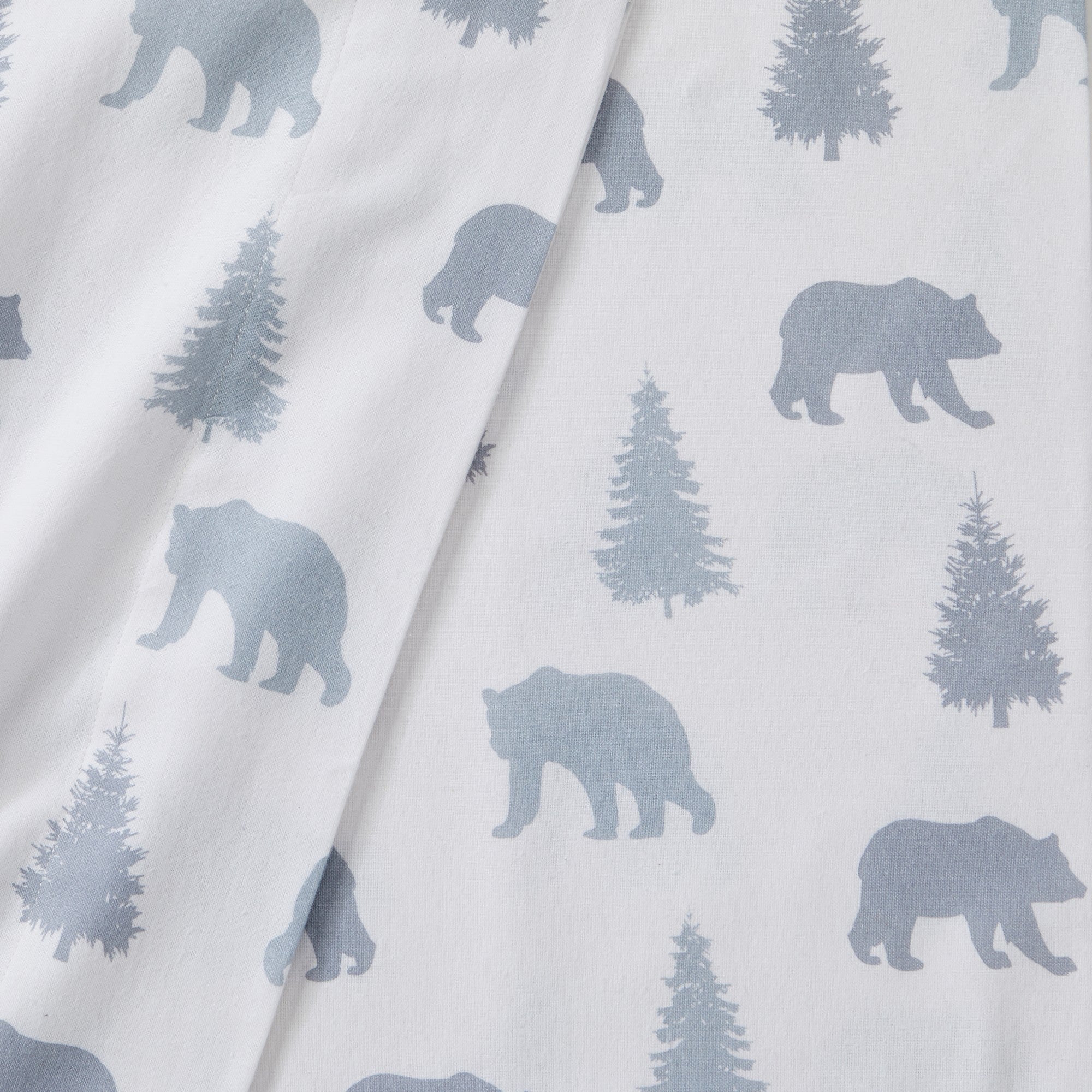 Printed 100% Turkish cotton flannel sheet set featuring assorted winter-inspired patterns, including woodland animals, snowflakes, trees, plaids, and seasonal motifs. Soft, cozy bedding shown in styled bedroom settings with close-up fabric details and folded sheet stacks in multiple designs.
