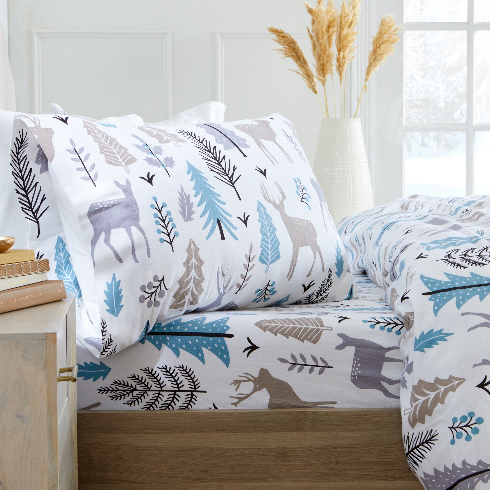 Printed 100% Turkish cotton flannel sheet set featuring assorted winter-inspired patterns, including woodland animals, snowflakes, trees, plaids, and seasonal motifs. Soft, cozy bedding shown in styled bedroom settings with close-up fabric details and folded sheet stacks in multiple designs.