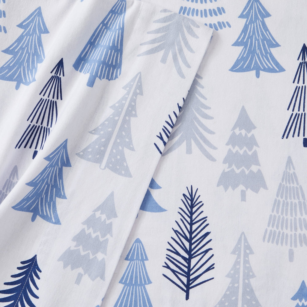 Printed 100% Turkish cotton flannel sheet set featuring assorted winter-inspired patterns, including woodland animals, snowflakes, trees, plaids, and seasonal motifs. Soft, cozy bedding shown in styled bedroom settings with close-up fabric details and folded sheet stacks in multiple designs.