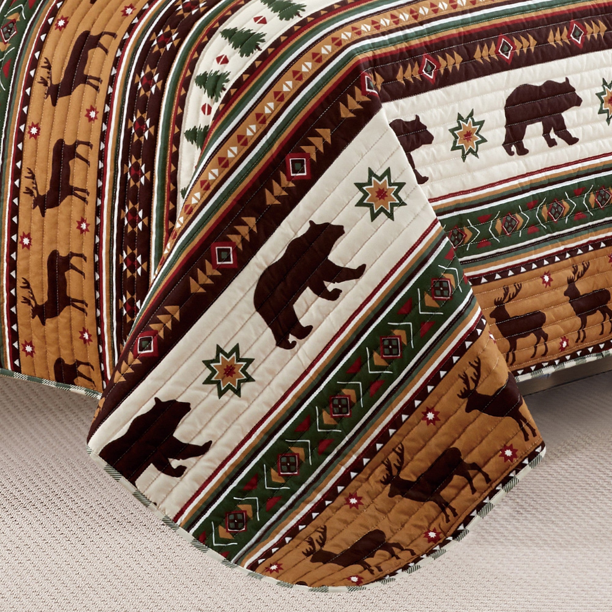 Cedar Creek Collection Lodge Quilt Set featuring rustic woodland-inspired patterns with bears, deer, trees, and plaid accents, shown in multiple colorways and styling views. Soft, reversible bedding with coordinating shams, displayed on beds and in close-up detail shots.