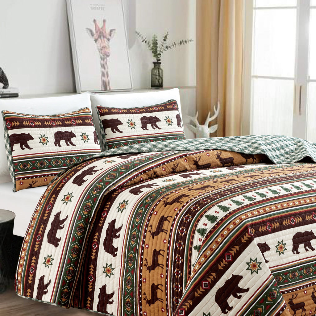 Cedar Creek Collection Lodge Quilt Set featuring rustic woodland-inspired patterns with bears, deer, trees, and plaid accents, shown in multiple colorways and styling views. Soft, reversible bedding with coordinating shams, displayed on beds and in close-up detail shots.
