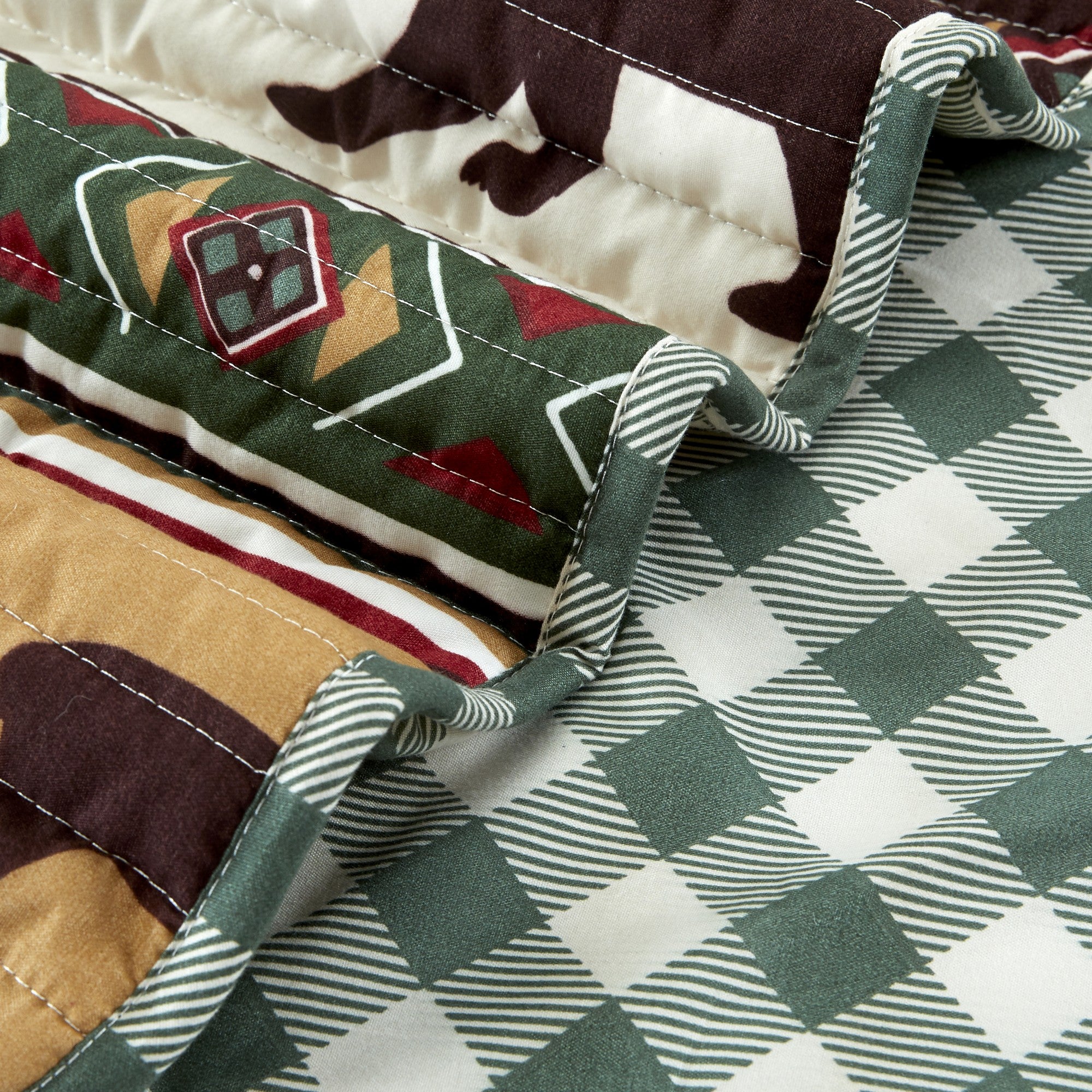 Cedar Creek Collection Lodge Quilt Set featuring rustic woodland-inspired patterns with bears, deer, trees, and plaid accents, shown in multiple colorways and styling views. Soft, reversible bedding with coordinating shams, displayed on beds and in close-up detail shots.