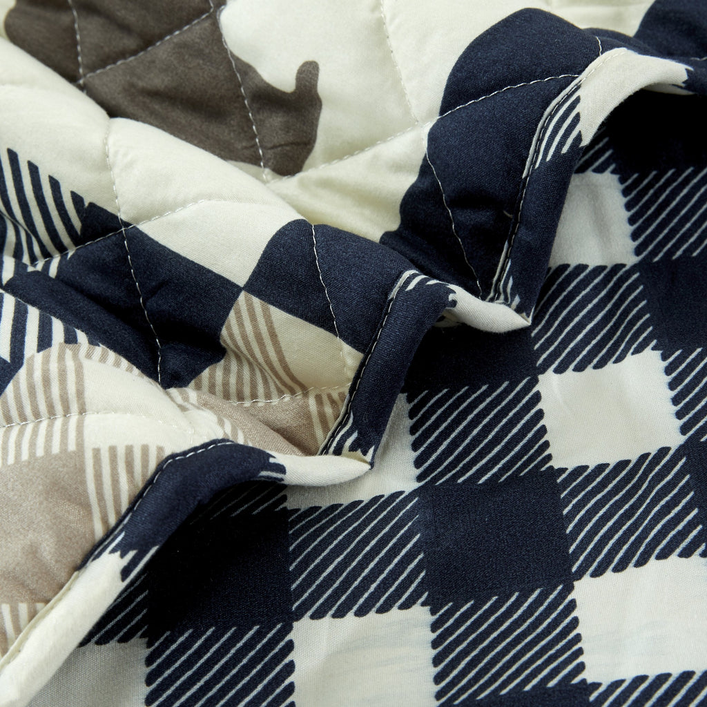 Orson Collection Lodge Quilt Set by Market & Place featuring soft microfiber construction and rustic lodge-inspired patchwork designs with plaid patterns and wildlife motifs. Coordinating shams and detailed fabric close-ups are shown in cozy bedroom settings, highlighting the reversible design and year-round comfort.