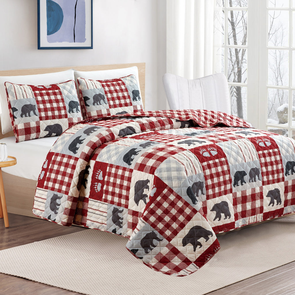 Orson Collection Lodge Quilt Set by Market & Place featuring soft microfiber construction and rustic lodge-inspired patchwork designs with plaid patterns and wildlife motifs. Coordinating shams and detailed fabric close-ups are shown in cozy bedroom settings, highlighting the reversible design and year-round comfort.