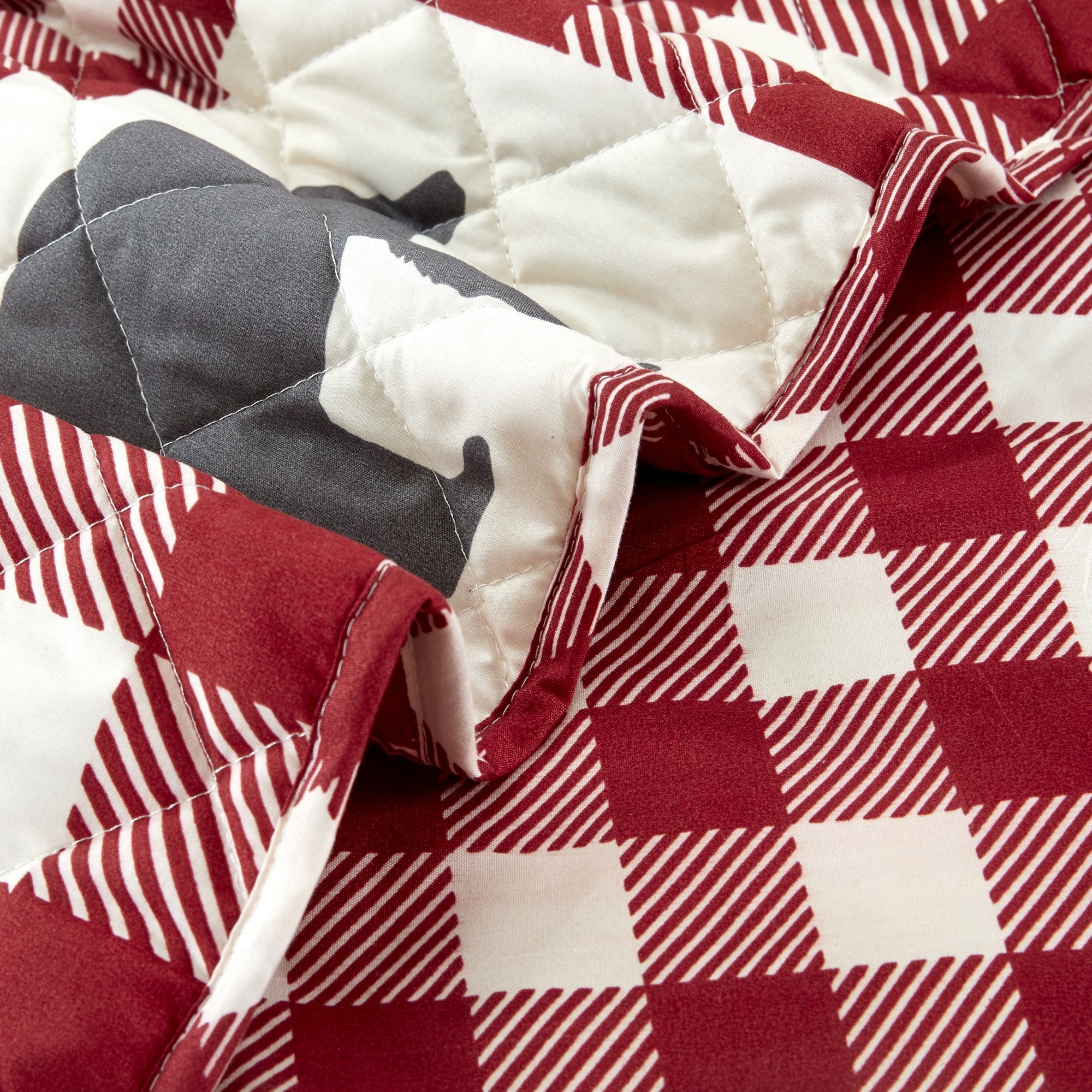 Orson Collection Lodge Quilt Set by Market & Place featuring soft microfiber construction and rustic lodge-inspired patchwork designs with plaid patterns and wildlife motifs. Coordinating shams and detailed fabric close-ups are shown in cozy bedroom settings, highlighting the reversible design and year-round comfort.