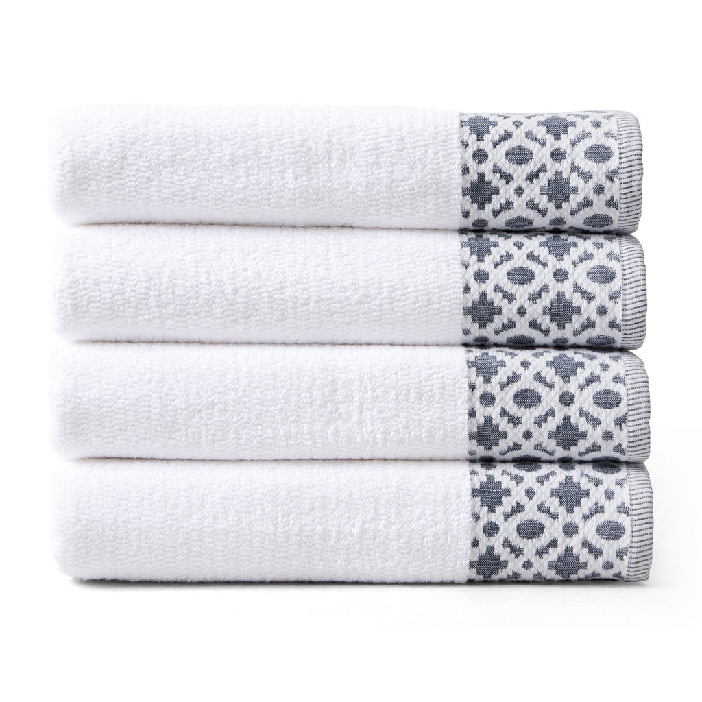 Nitra Collection Cotton Luxury Bath Towels by Market & Place featuring premium 100% cotton construction with an elegant geometric dobby border. Available in multiple colors and set configurations, including bath towels, hand towels, and washcloths, shown folded and stacked to highlight their soft, plush, and absorbent texture.