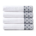 Nitra Collection Cotton Luxury Bath Towels by Market & Place featuring premium 100% cotton construction with an elegant geometric dobby border. Available in multiple colors and set configurations, including bath towels, hand towels, and washcloths, shown folded and stacked to highlight their soft, plush, and absorbent texture.