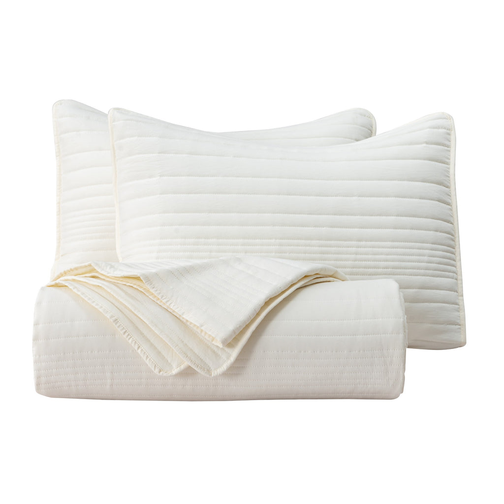 Parker Collection Solid Embroidered Quilt Set by Market & Place featuring soft microfiber construction and elegant channel embroidery. Available in multiple colors with coordinating shams and detailed fabric close-ups, styled in a modern bedroom setting.