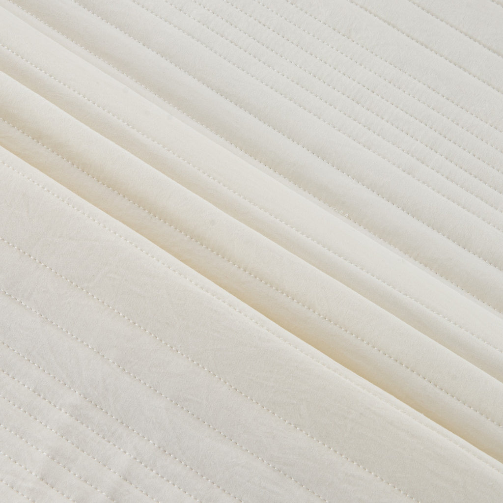 Parker Collection Solid Embroidered Quilt Set by Market & Place featuring soft microfiber construction and elegant channel embroidery. Available in multiple colors with coordinating shams and detailed fabric close-ups, styled in a modern bedroom setting.