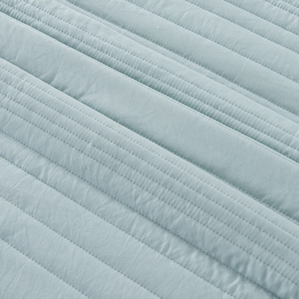 Parker Collection Solid Embroidered Quilt Set by Market & Place featuring soft microfiber construction and elegant channel embroidery. Available in multiple colors with coordinating shams and detailed fabric close-ups, styled in a modern bedroom setting.