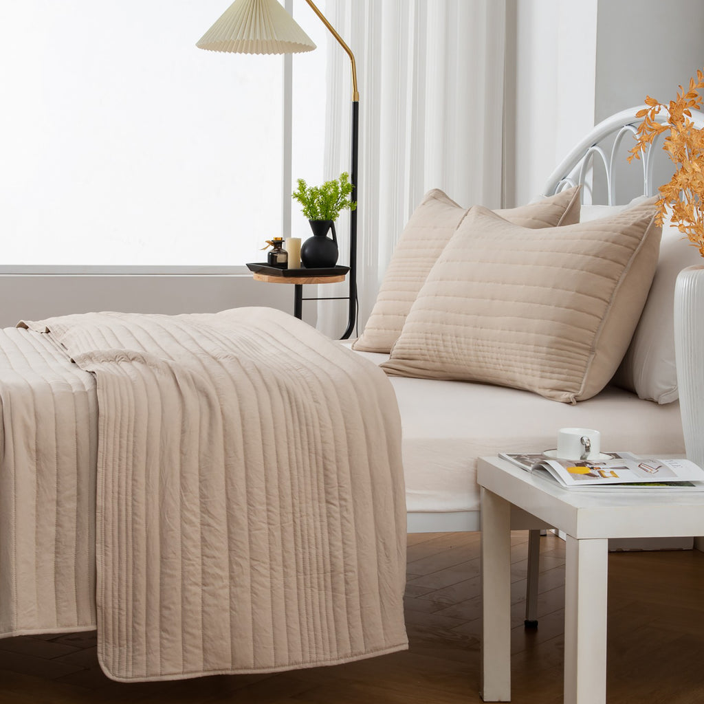 Parker Collection Solid Embroidered Quilt Set by Market & Place featuring soft microfiber construction and elegant channel embroidery. Available in multiple colors with coordinating shams and detailed fabric close-ups, styled in a modern bedroom setting.