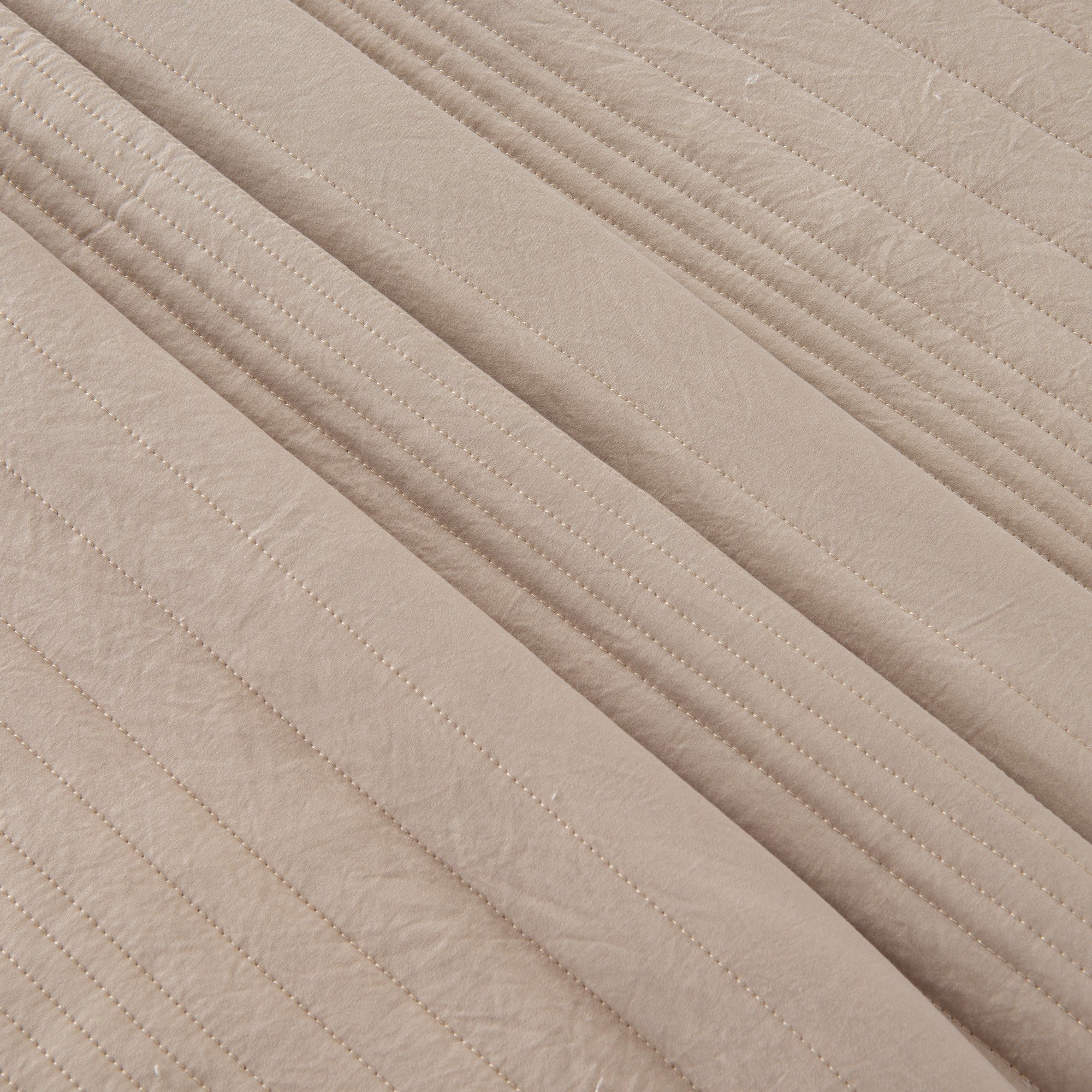 Parker Collection Solid Embroidered Quilt Set by Market & Place featuring soft microfiber construction and elegant channel embroidery. Available in multiple colors with coordinating shams and detailed fabric close-ups, styled in a modern bedroom setting.