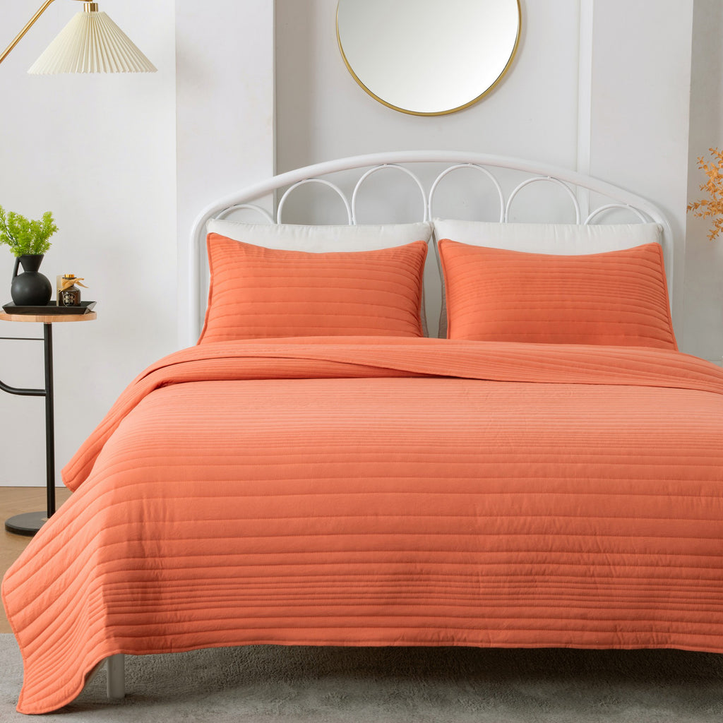 Parker Collection Solid Embroidered Quilt Set by Market & Place featuring soft microfiber construction and elegant channel embroidery. Available in multiple colors with coordinating shams and detailed fabric close-ups, styled in a modern bedroom setting.
