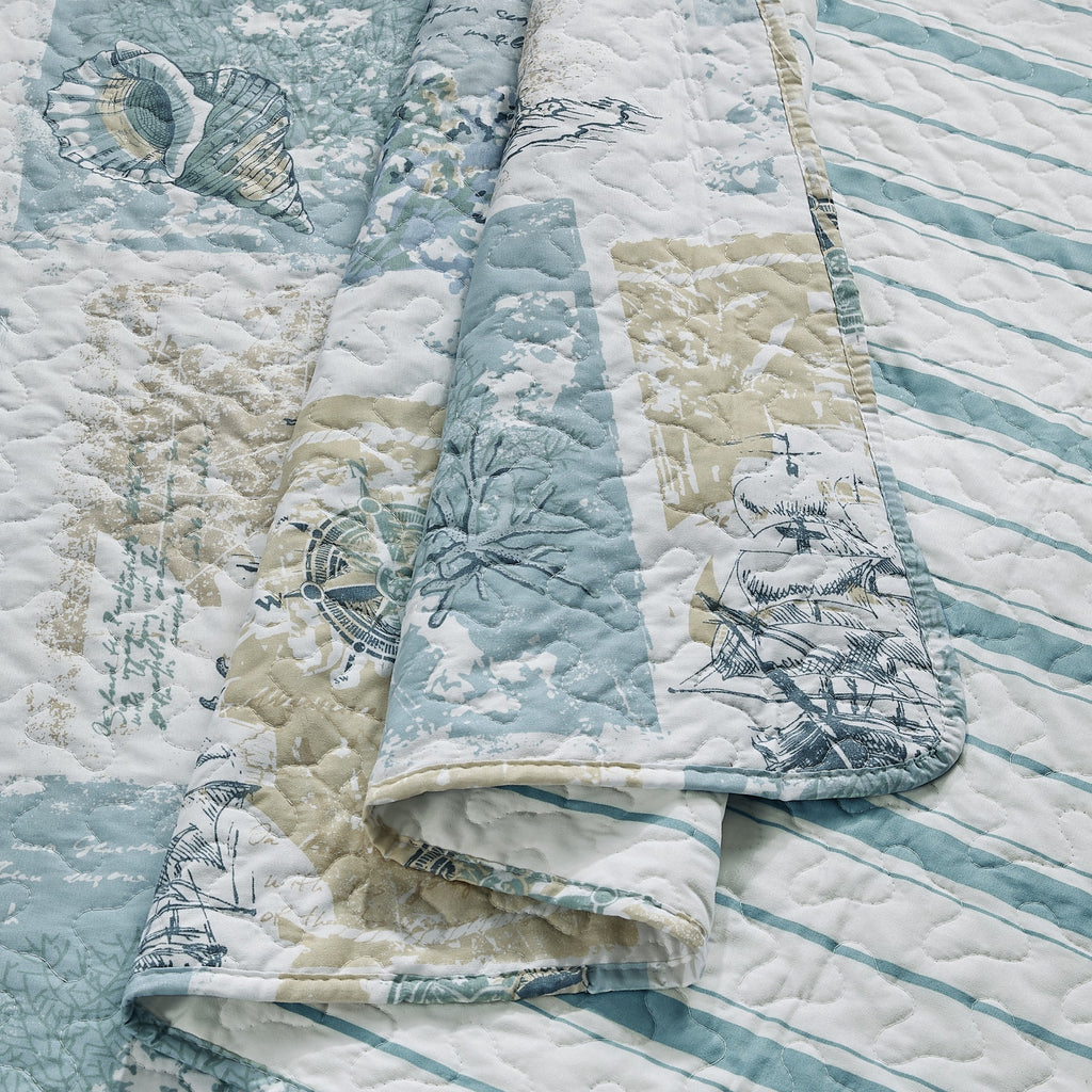 Coastal Collection Reversible Quilt Set by Market & Place featuring soft microfiber construction and coastal-inspired prints, including seashells, starfish, seahorses, coral, and ocean motifs. Coordinating shams and detailed fabric close-ups are shown in a bright bedroom setting, highlighting the reversible design and all-season comfort.