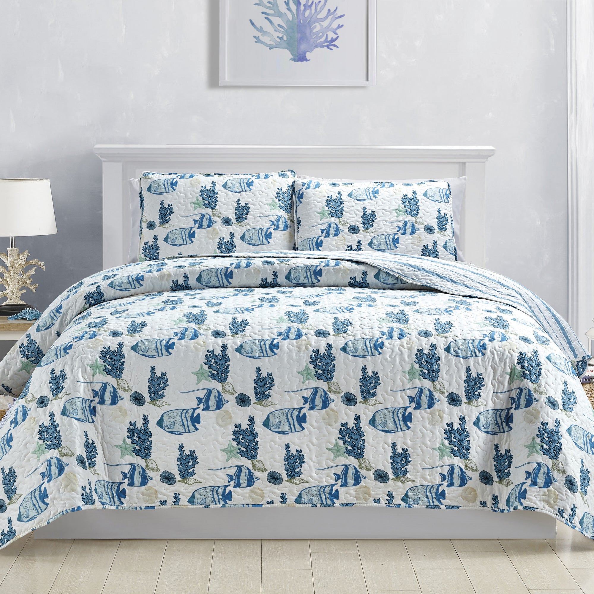 Coastal Collection Reversible Quilt Set by Market & Place featuring soft microfiber construction and coastal-inspired prints, including seashells, starfish, seahorses, coral, and ocean motifs. Coordinating shams and detailed fabric close-ups are shown in a bright bedroom setting, highlighting the reversible design and all-season comfort.