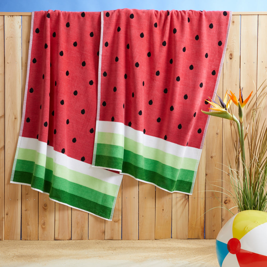100% cotton velour beach towel featuring a colorful jacquard design, displayed on a wooden deck. Soft, absorbent, and durable, perfect for beach days, poolside lounging, and summer travel.