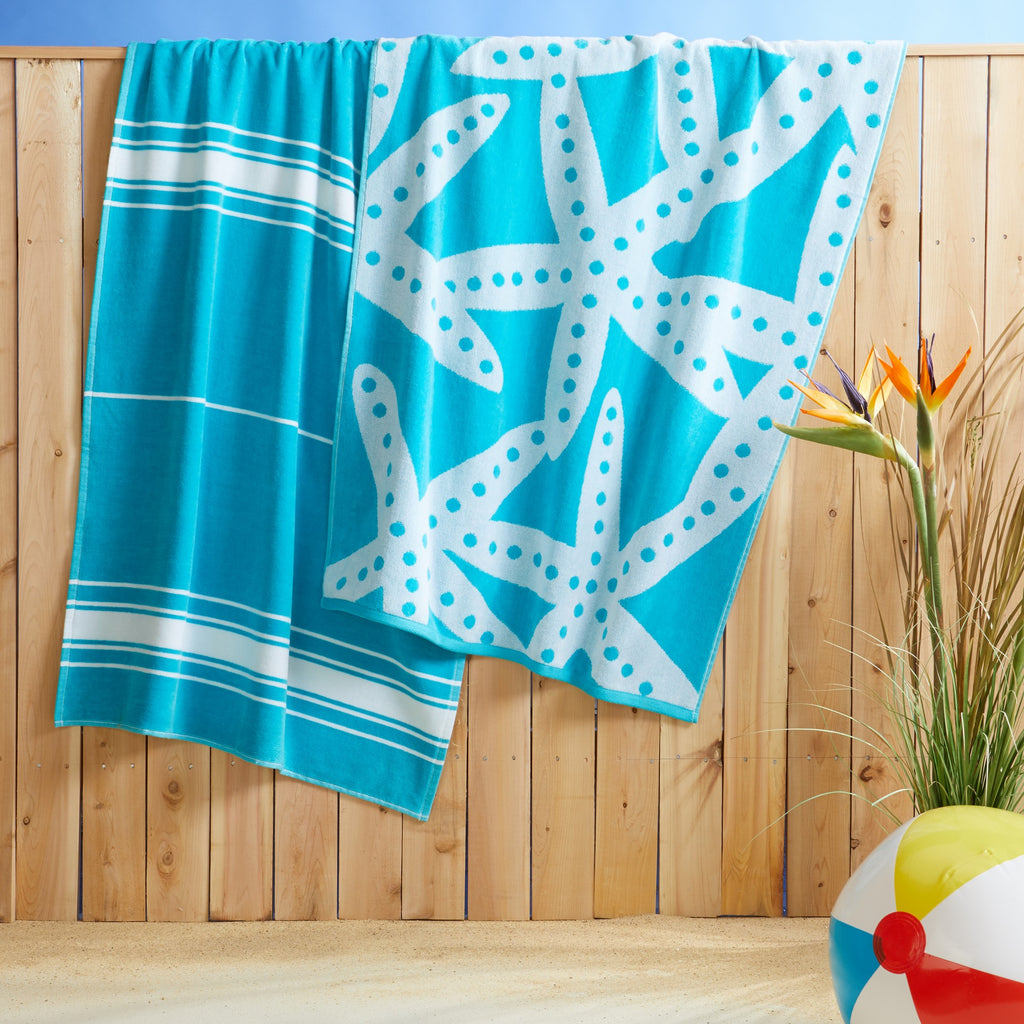 100% cotton velour beach towel featuring a colorful jacquard design, displayed on a wooden deck. Soft, absorbent, and durable, perfect for beach days, poolside lounging, and summer travel.