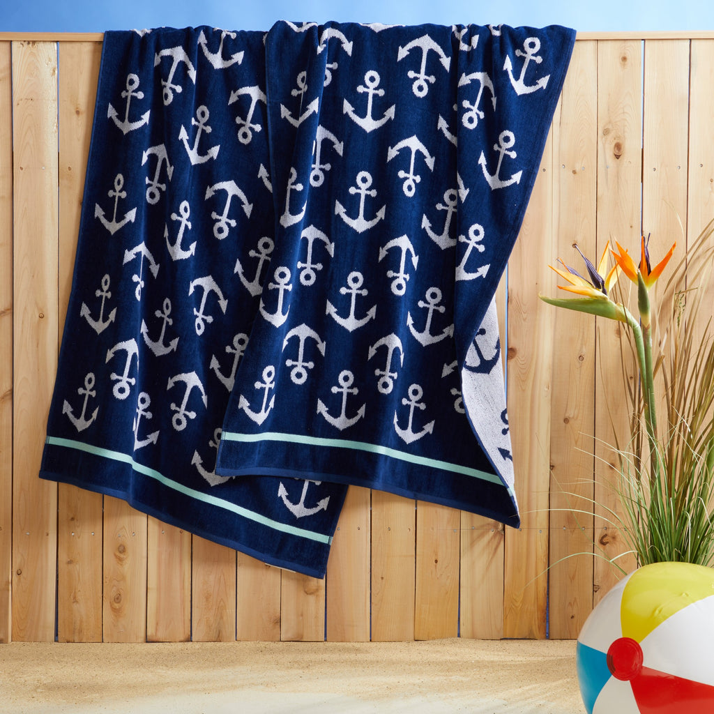 100% cotton velour beach towel featuring a colorful jacquard design, displayed on a wooden deck. Soft, absorbent, and durable, perfect for beach days, poolside lounging, and summer travel.